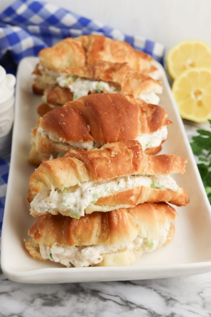 crab salad croissant sandwiches on white serving tray