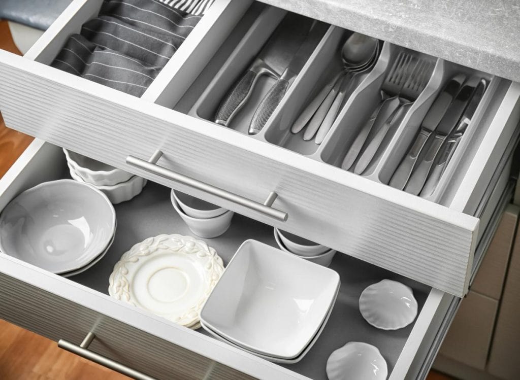 kitchen drawers filled with dishes and silverware