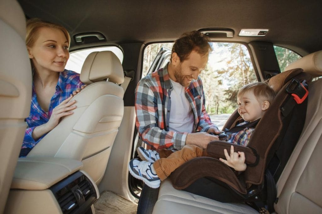 buckling kids in for a road trip