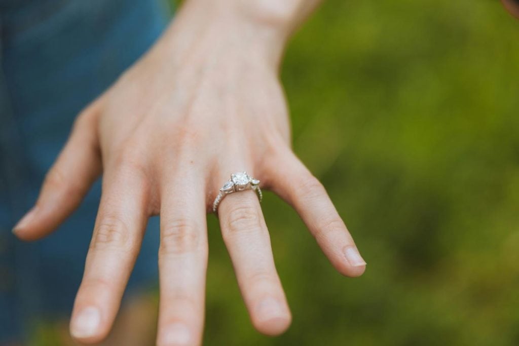 hand with engagement ring, fingers spread apart