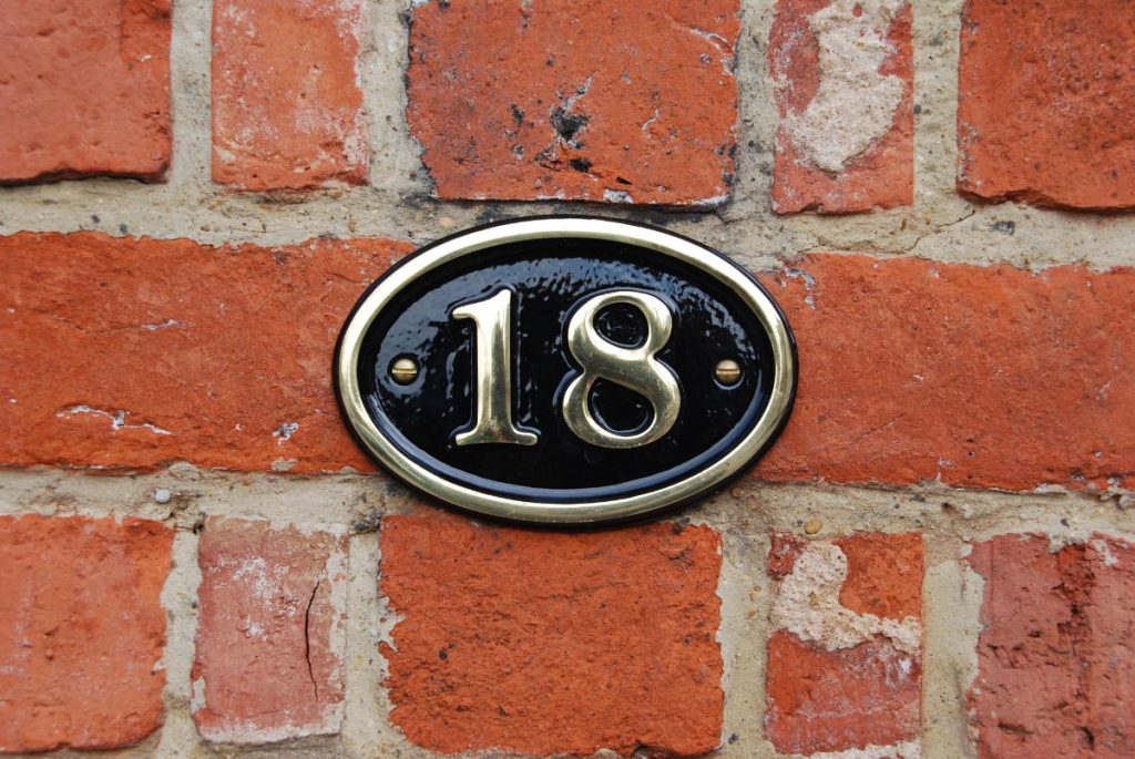 house number 18 on brick wall