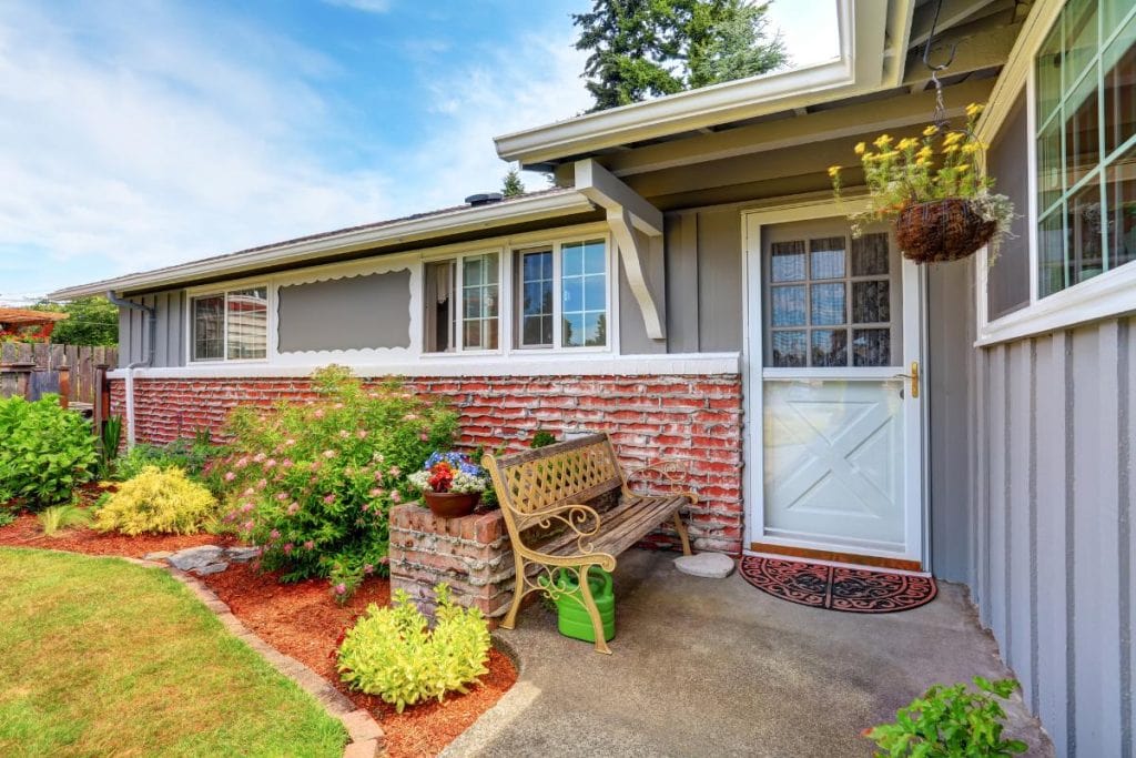 house with cute garden and brick wall