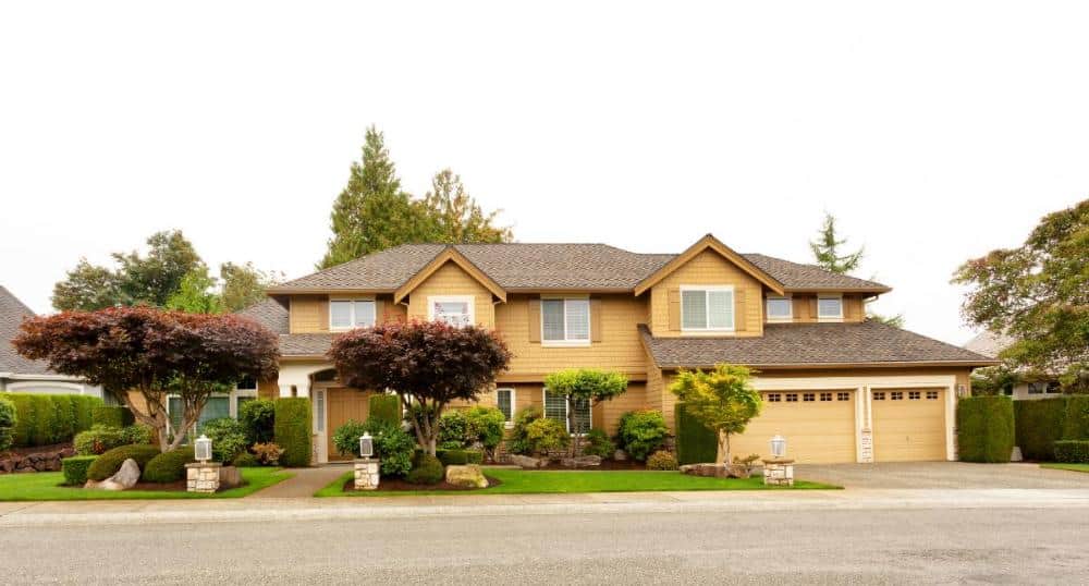 large suburban house with 3 car garage and nice pathway to house