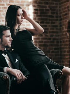man and woman in black tie clothing