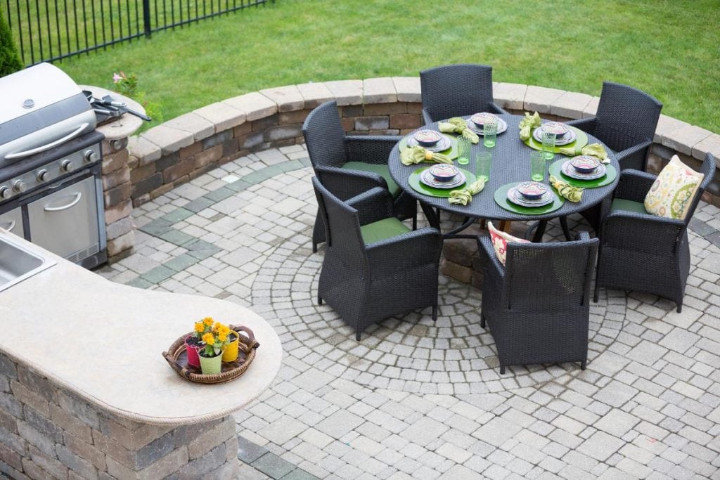 nice outdoor dining area on patio with outdoor kitchen