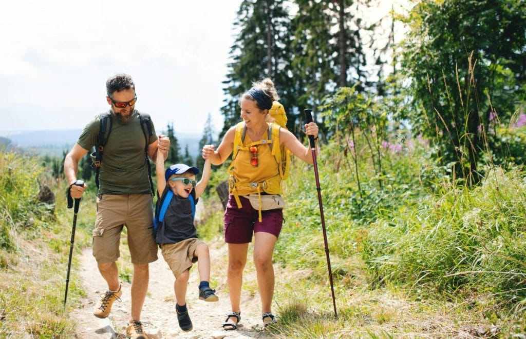 mom, dad, and little boy on a hike