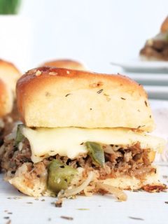 philly cheesesteak sliders on white background