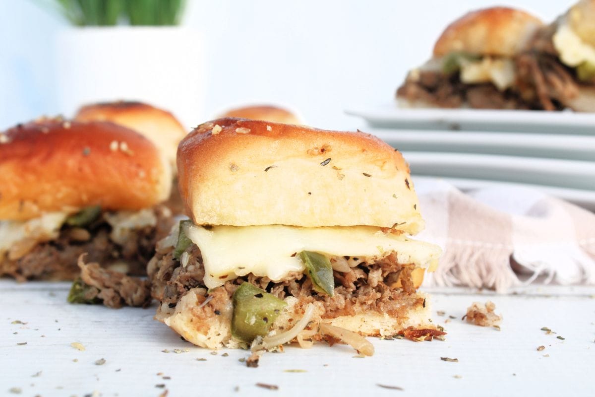 group of philly cheesesteak sliders on white background