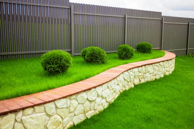 brown fencing and well-landscaped yard