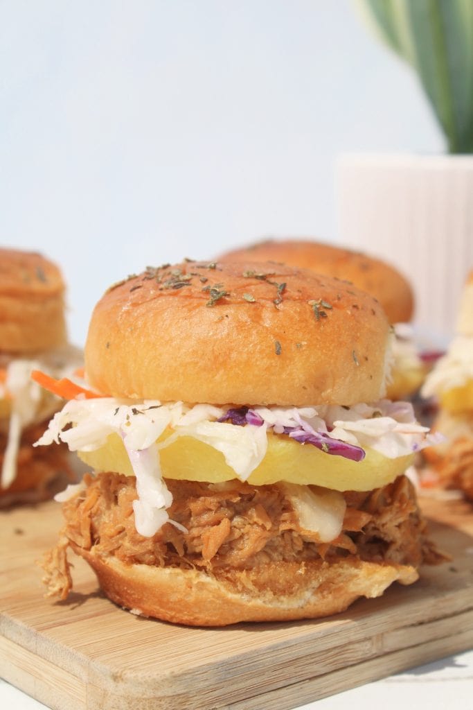 up-close view of a chicken teriyaki sandwich slider with pineapple and coleslaw