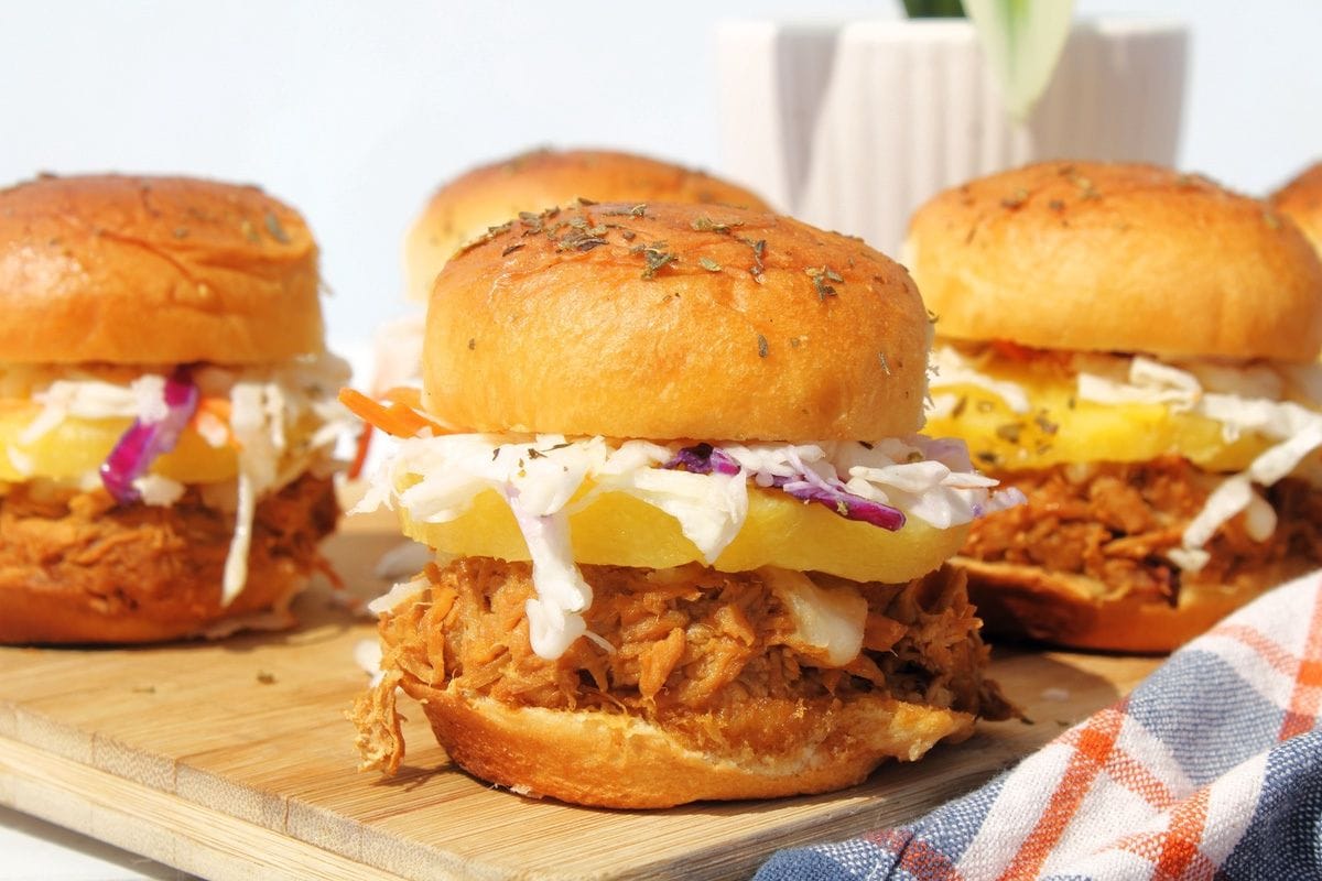 group of teriyaki chicken sliders on wood cutting board