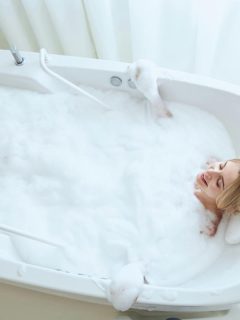 woman soaking in a white tub