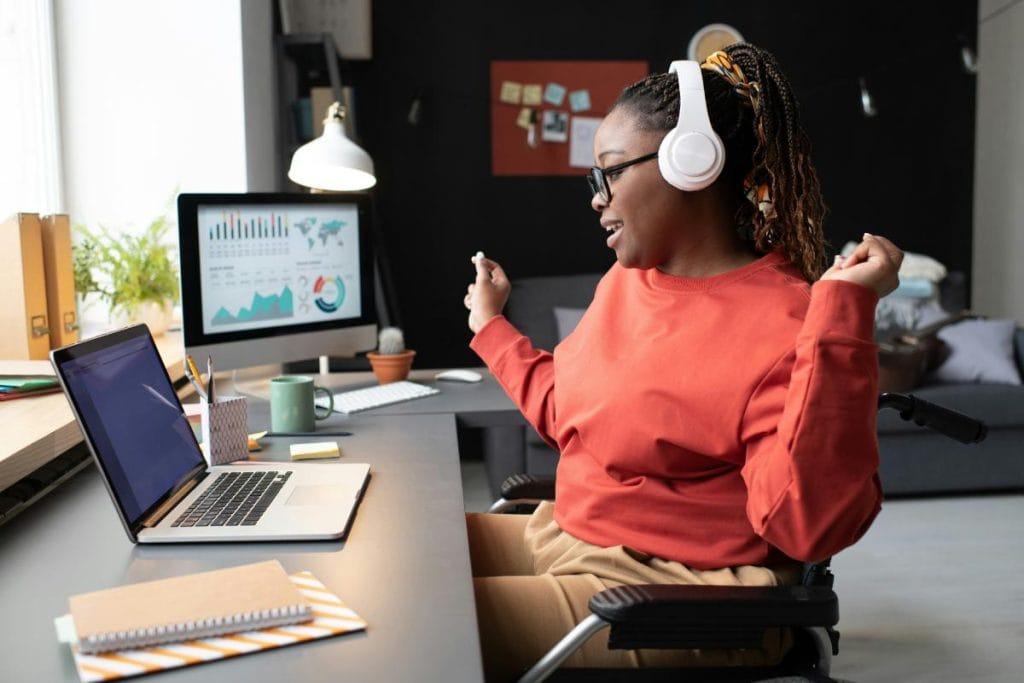 woman using laptop and headphones