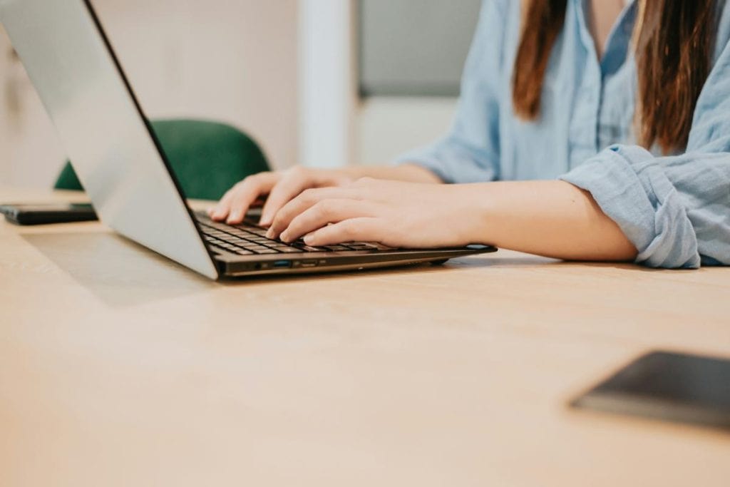 woman's hands on laptop