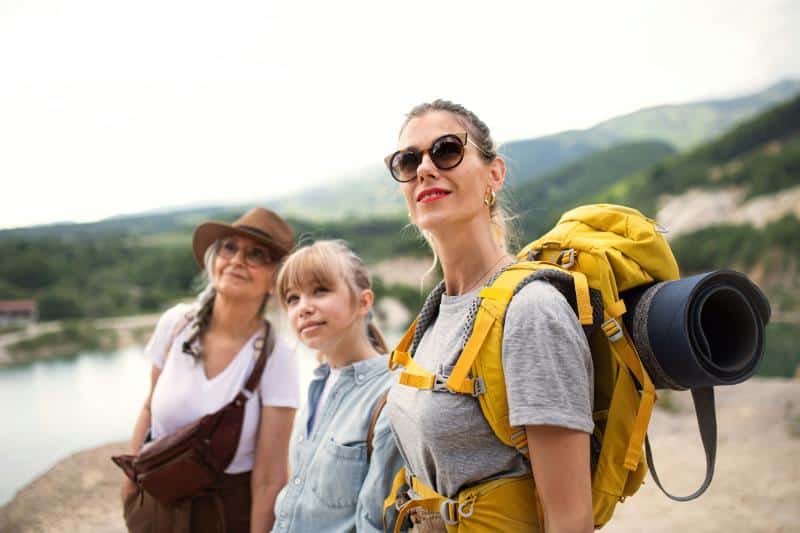 grandmother, granddaughter, and mother on a hike