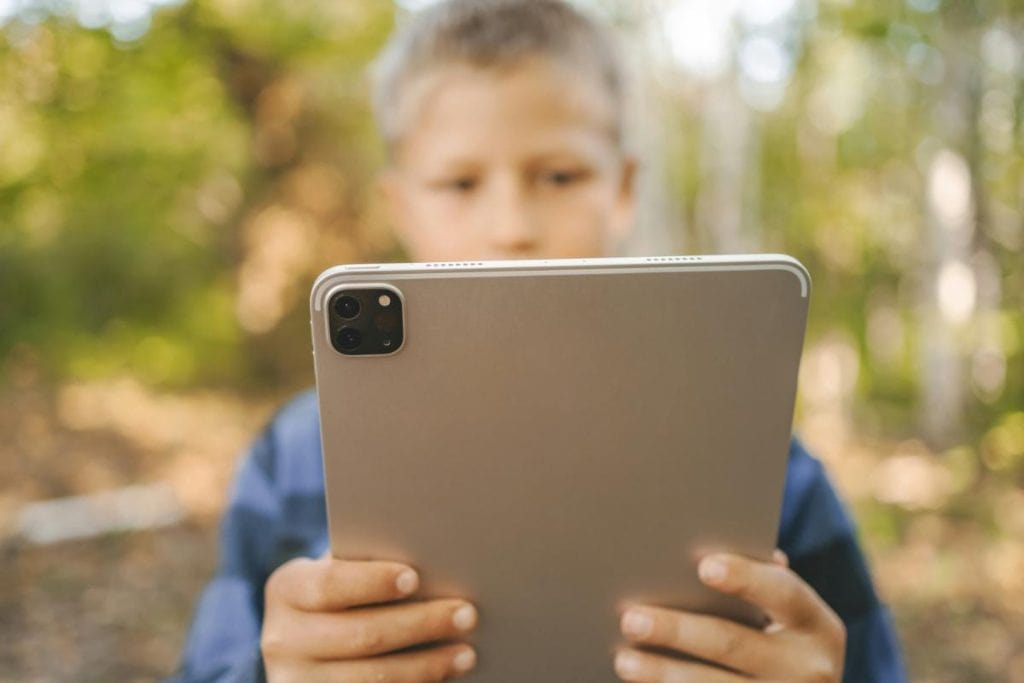 boy using a tablet outdoors