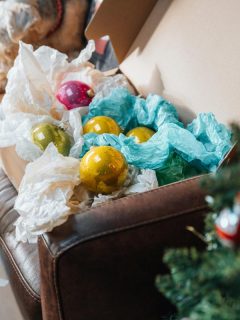 christmas ornaments wrapped in tissue paper in a box