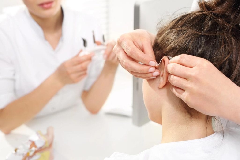 placing hearing aid in childs ear