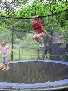 2 sisters jumping on a trampoline