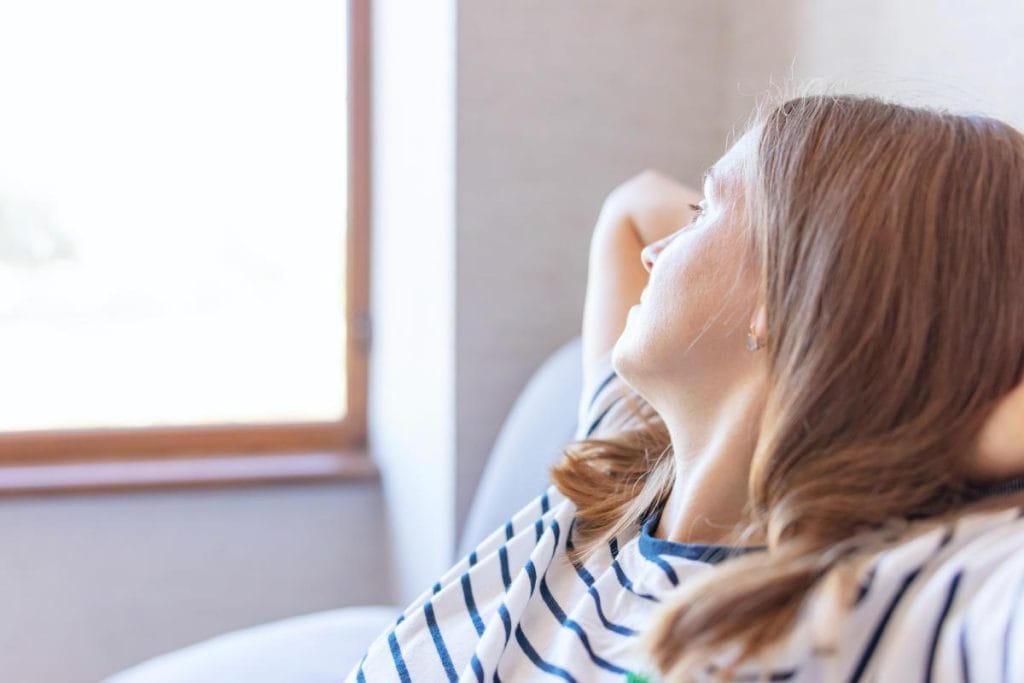 caucasian woman looking out window