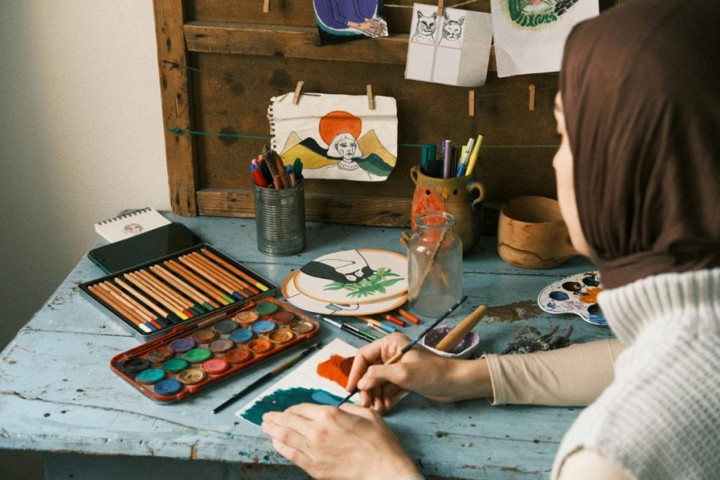 woman using watercolor paints