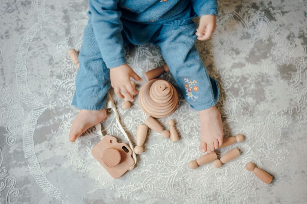 toddler playing with wooden toys