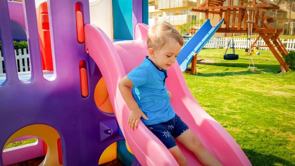 small boy on a colorful slide