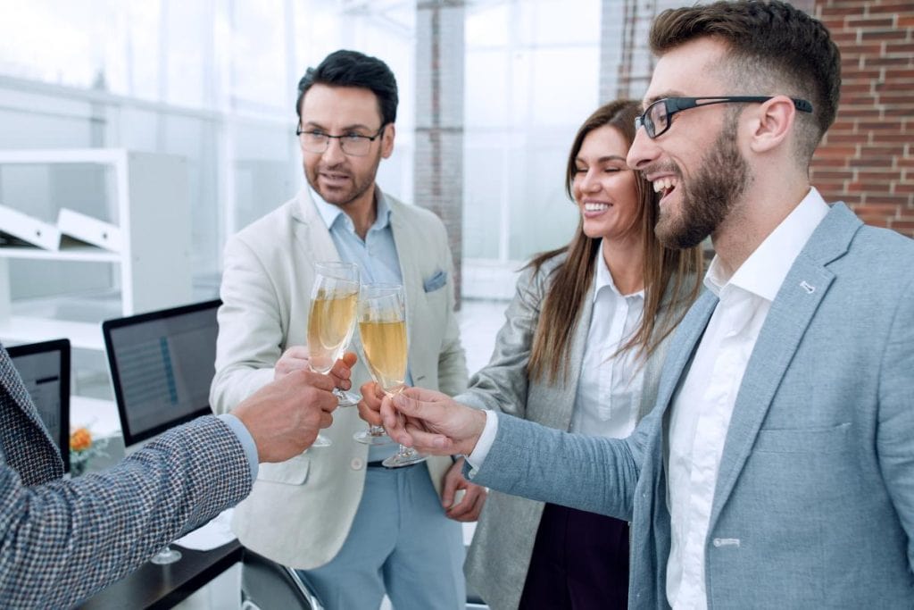 coworkers drinking champagne at the office