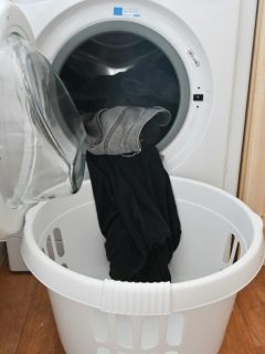 clothes in dryer spilling out into laundry basket