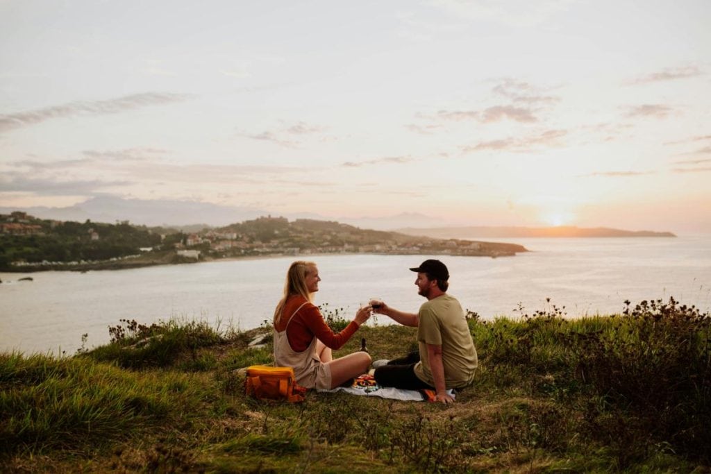 couple having a picnic overlooking the water