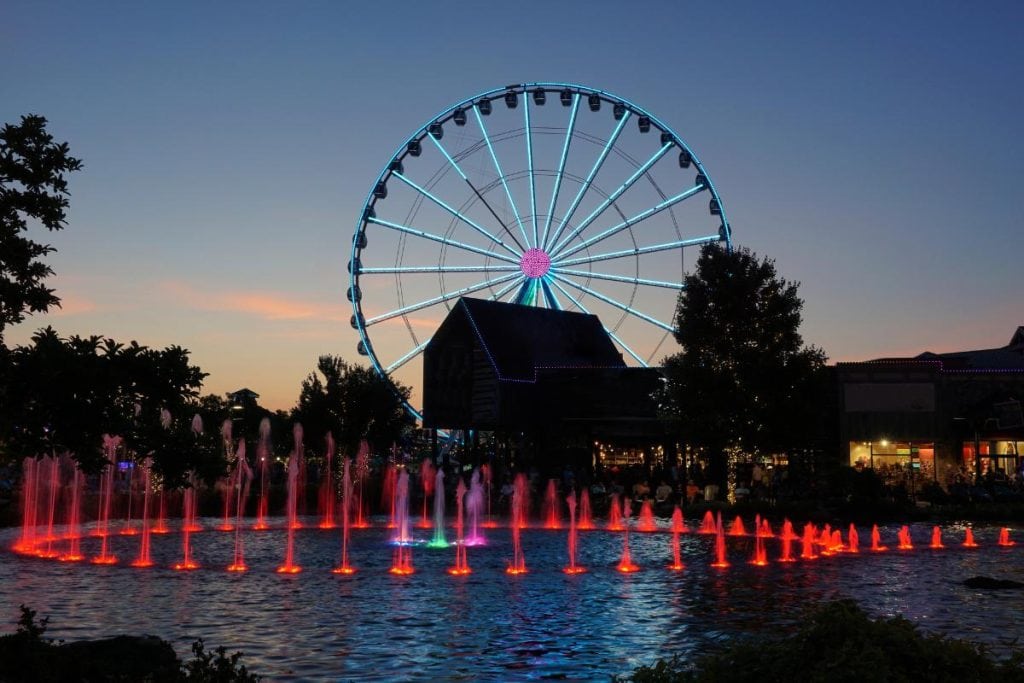 fountains and ferris wheel in Pigeon Forge at dusk