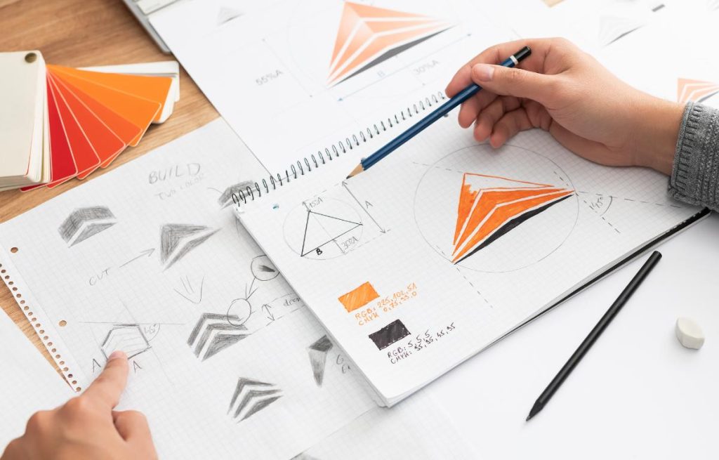 graphic designer drawing logo concepts