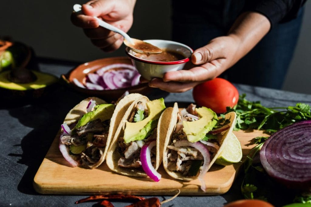 woman preparing Mexican pork tacos