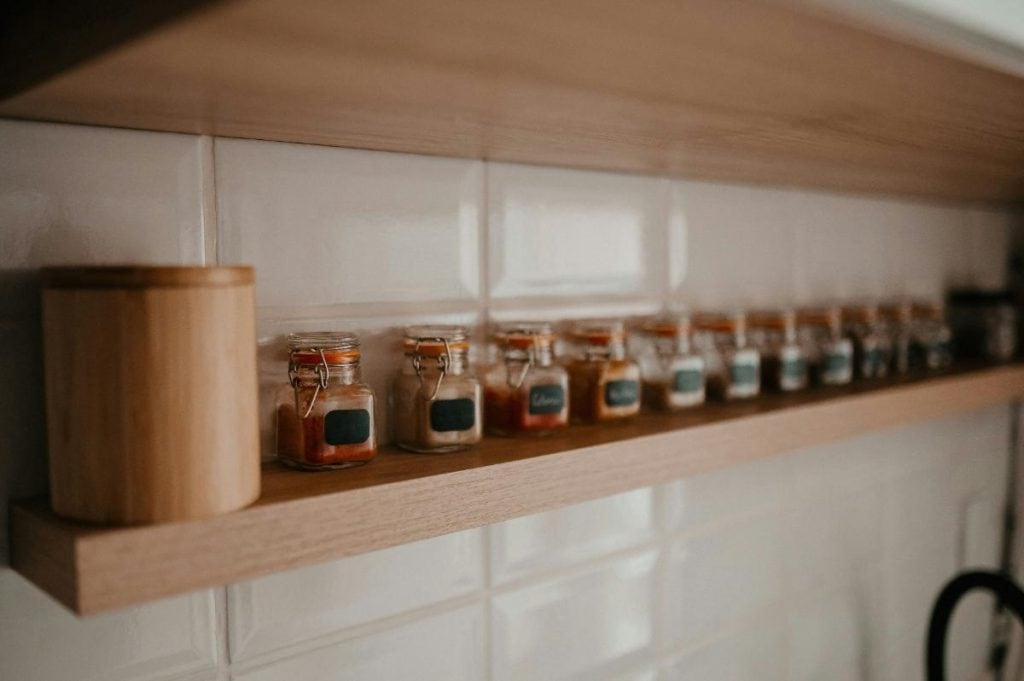 spices in small jars lined up on a shelf