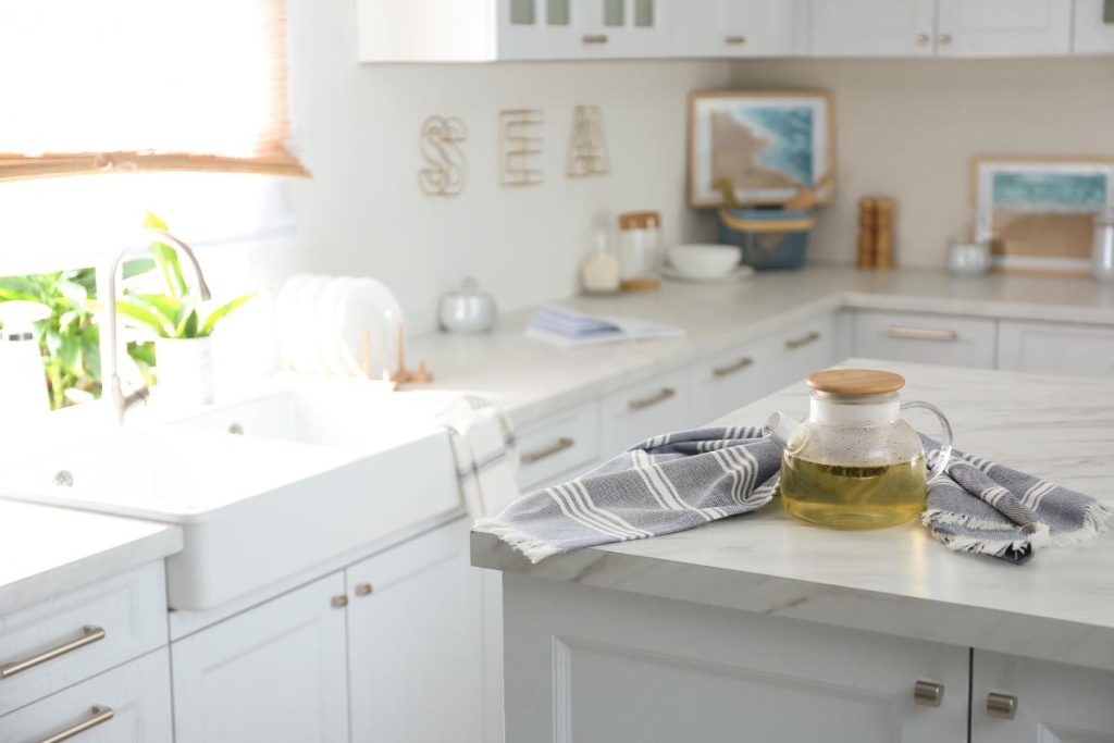 teapot on countertop in a white coastal-themed kitchen