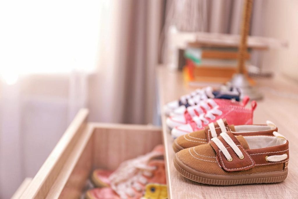 colorful toddler shoes on chest of drawers