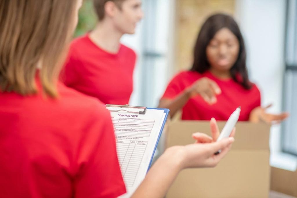 volunteers in red shirts