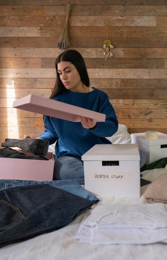 woman sorting clothes into boxes