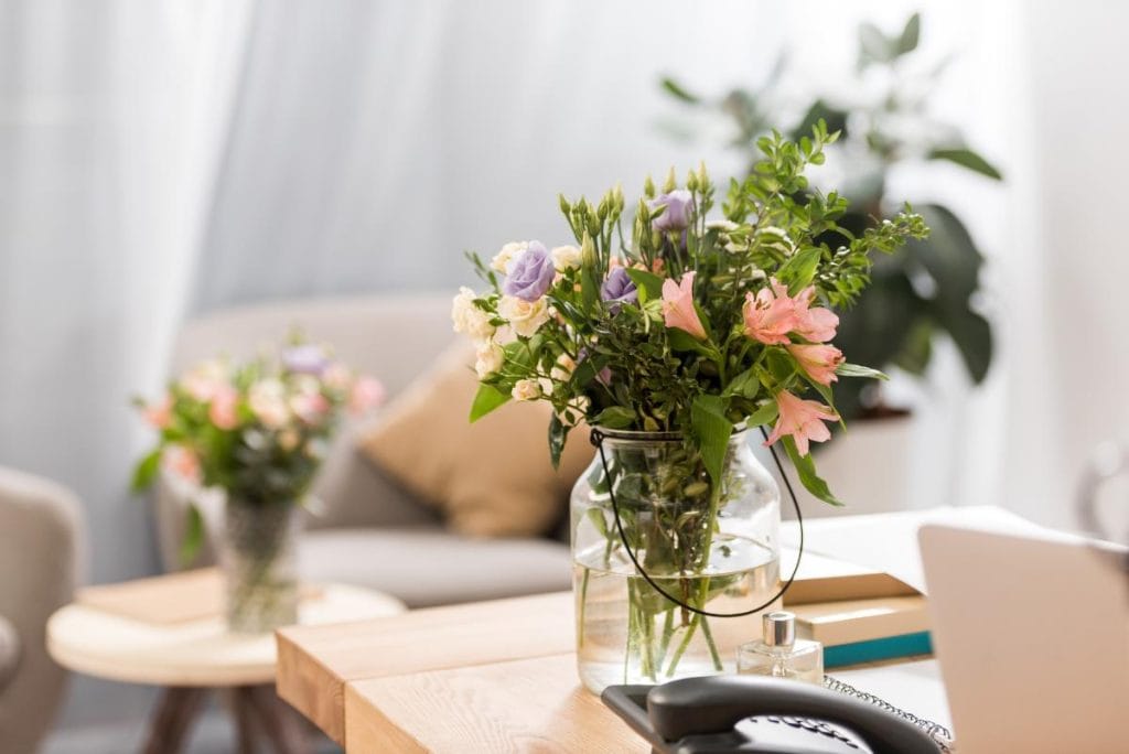 flowers in a clear vase in an office setting