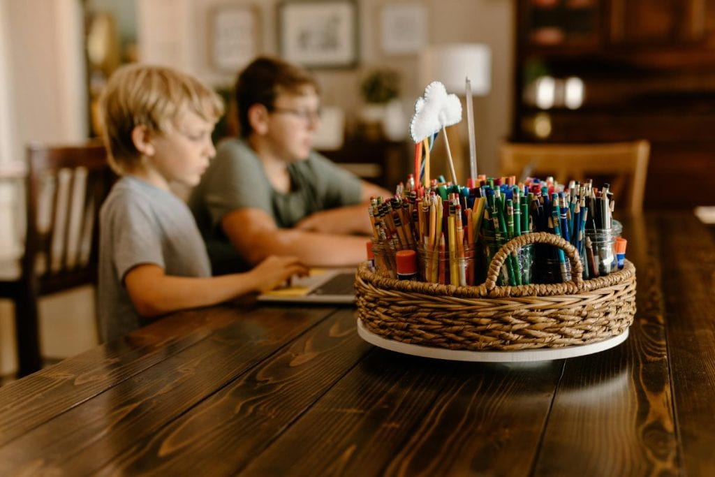 kids at large wooden table learning at home