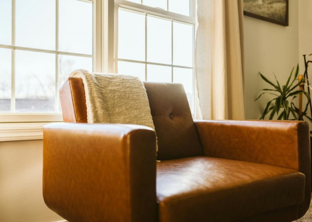 leather chair in front of double windows