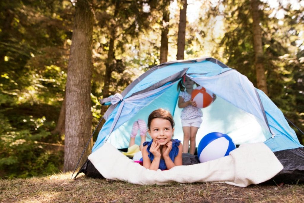 little girls playing in a tent