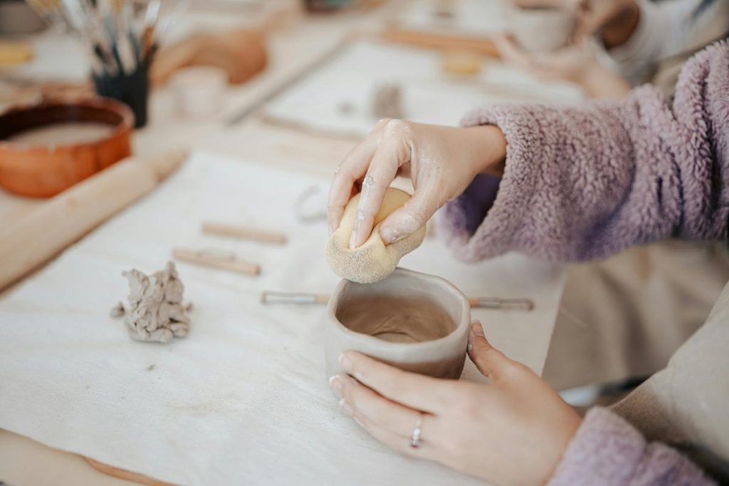 woman making pottery with her hands