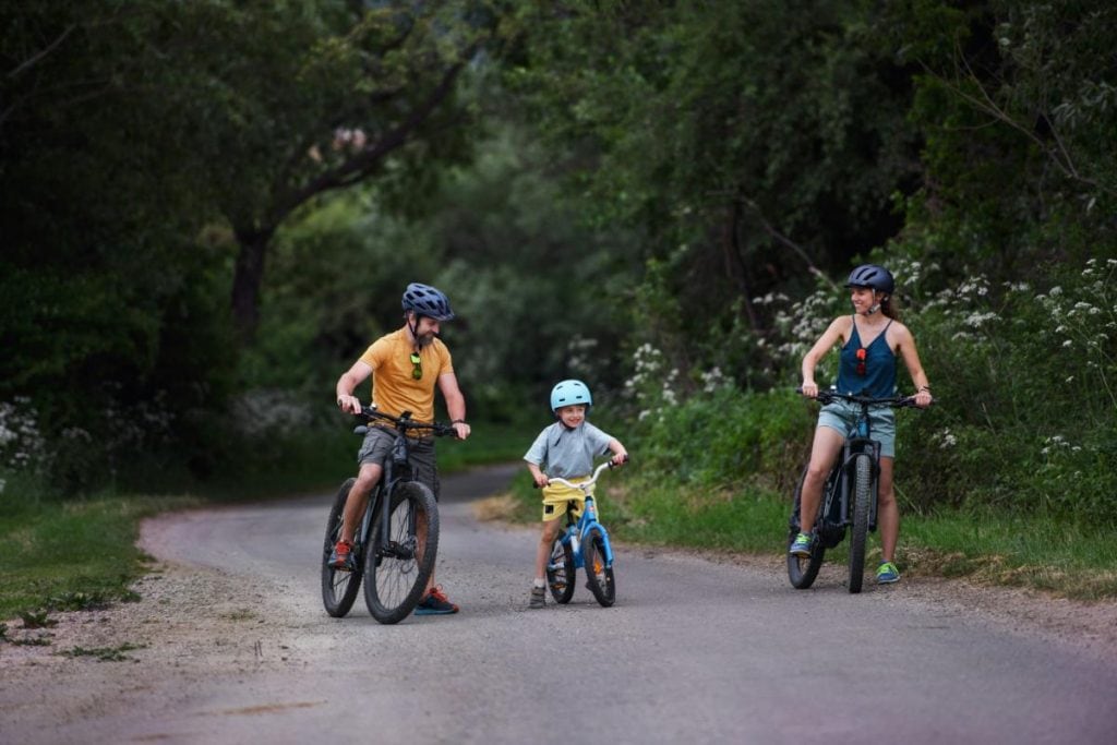 mom, dad, and son riding bicycles