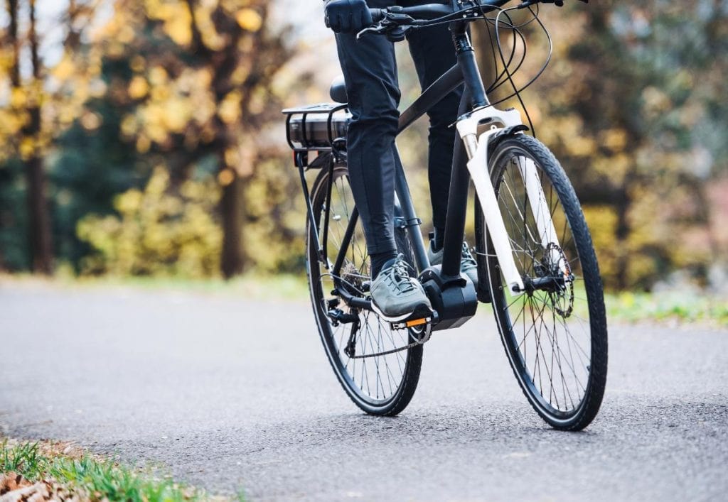 person standing on bike pedals