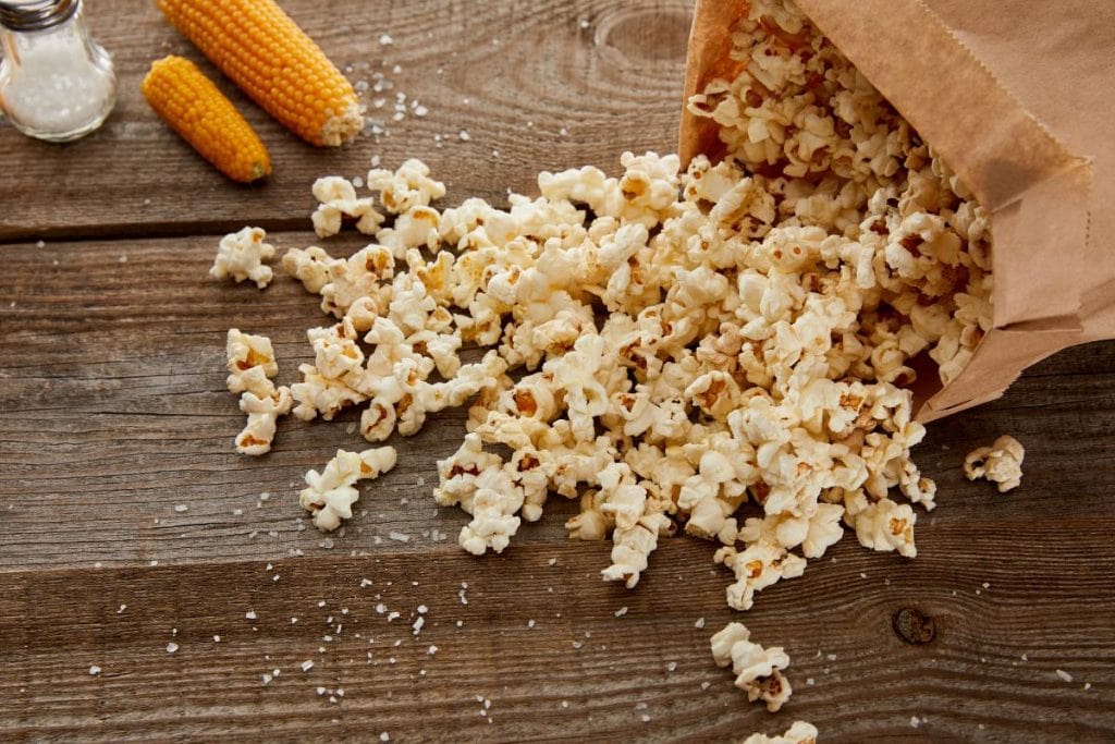 popcorn spilling out of a paper bag