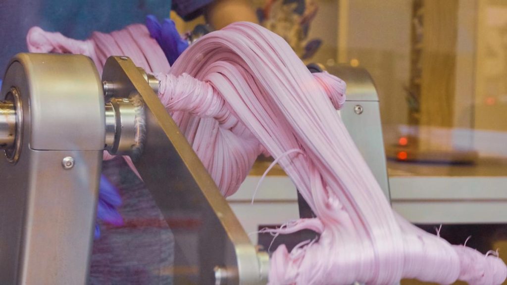 stretching and pulling taffy on a candy making machine