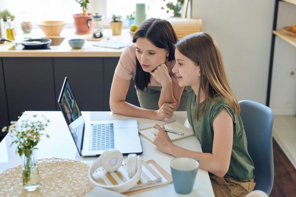 teen daughter using laptop