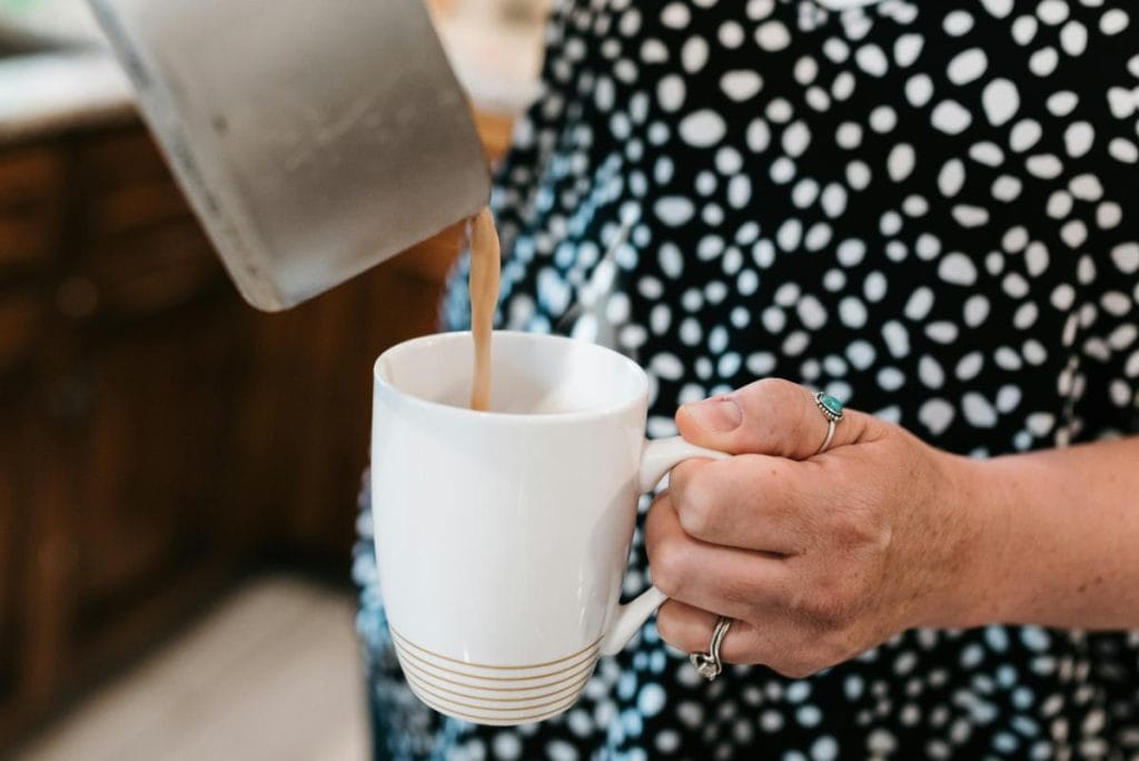 woman pouring drink into cup