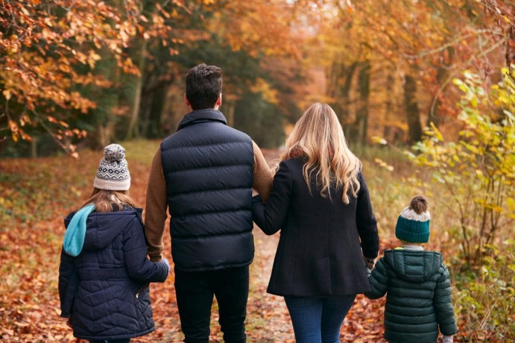 family walking along a road on an autumn day